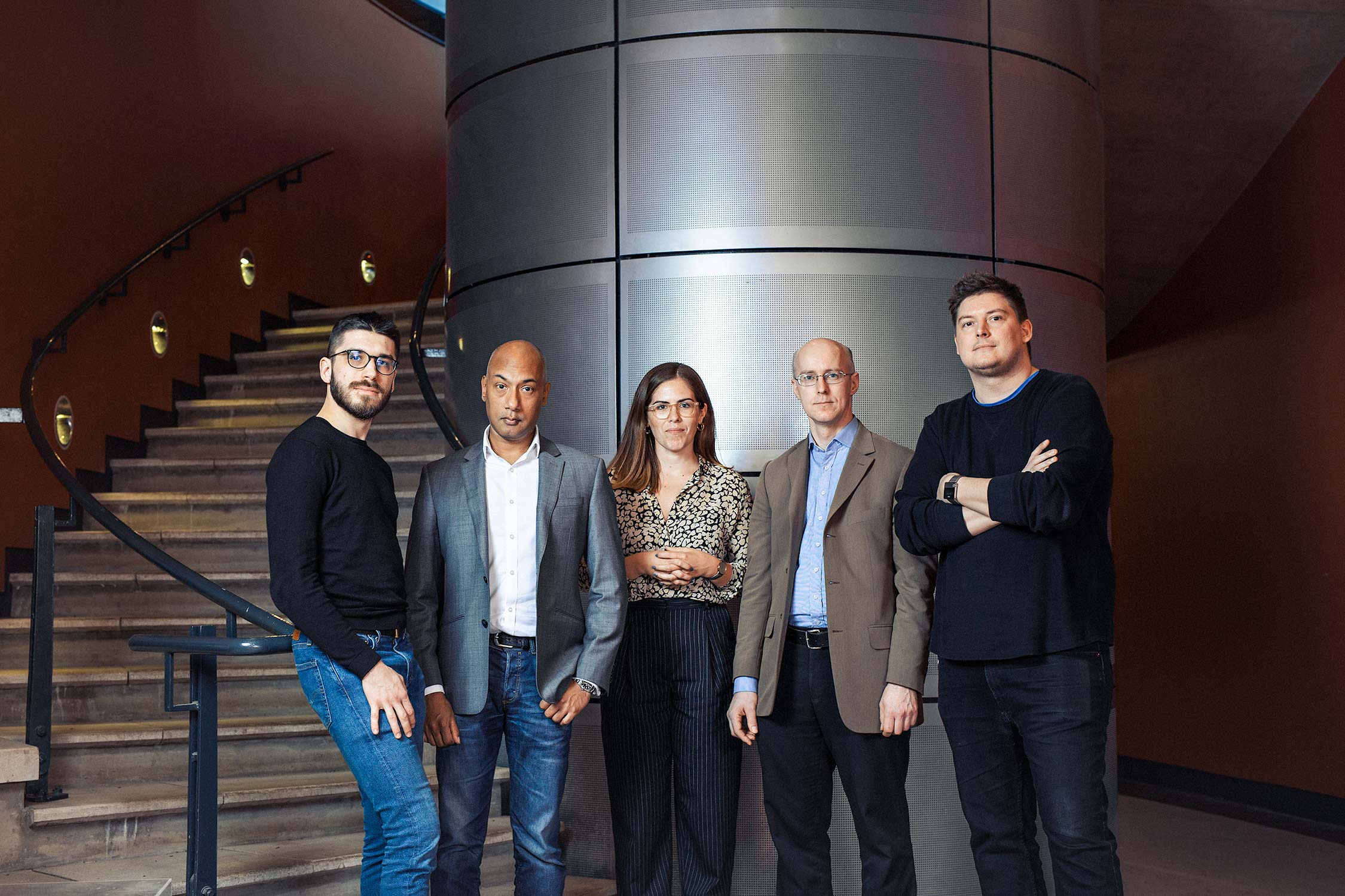 Professional portrait photography of a group of academics at the University of Cambridge.