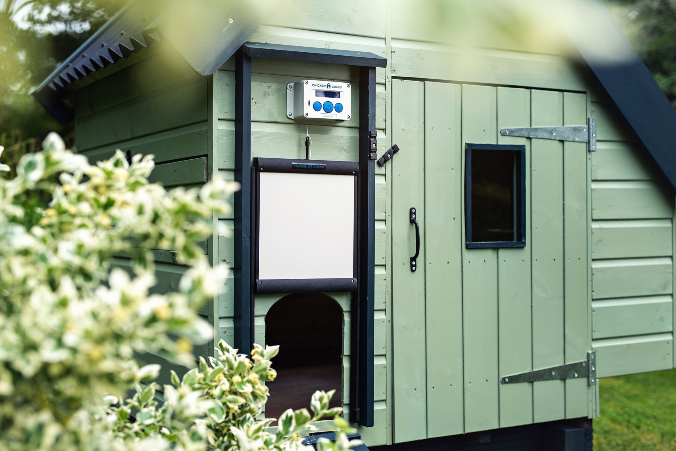 Location product photography of a luxury chicken coop and Chickenguard unit and door attached.