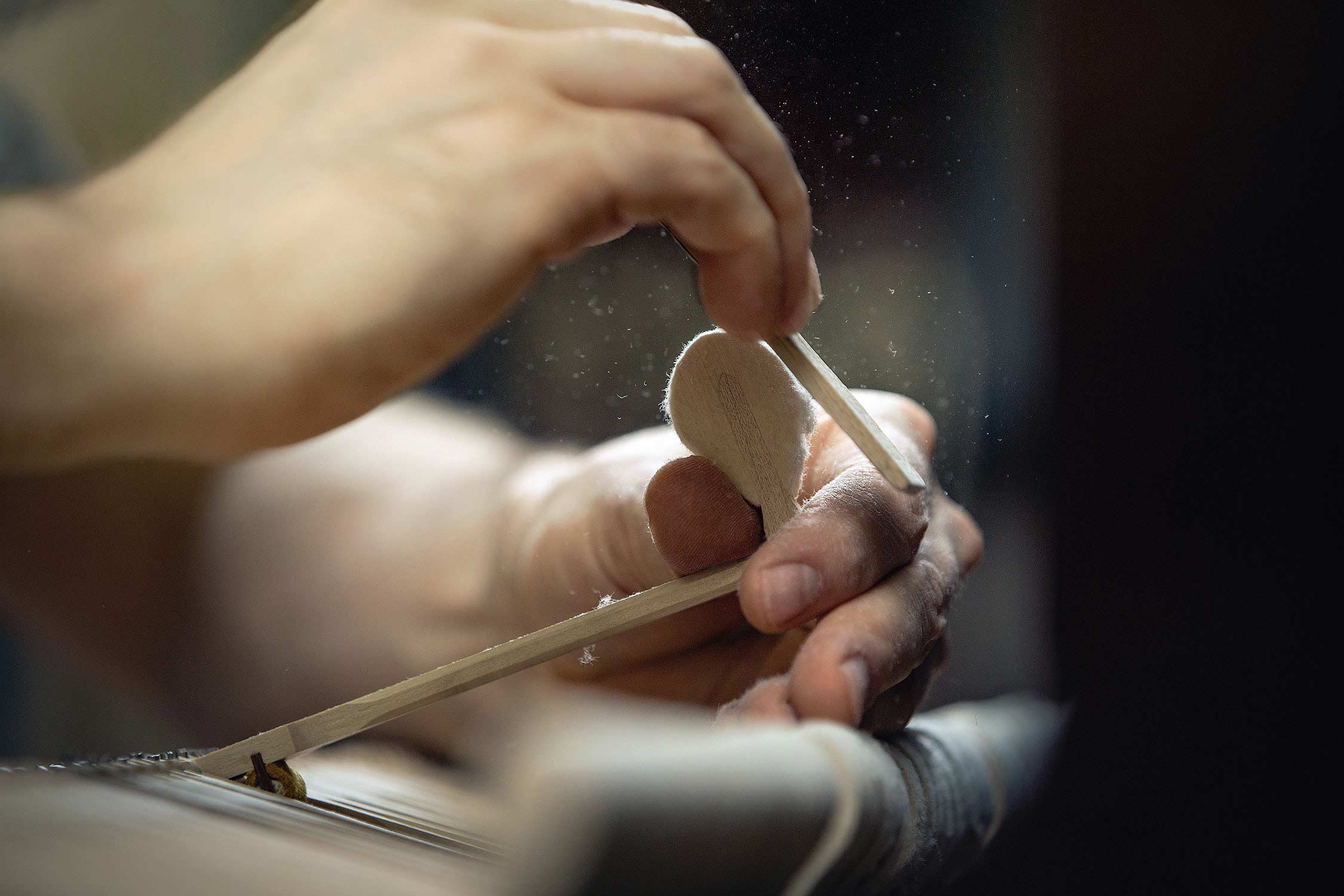 Professional editorial photography detail of the hammer sanding process for pianos at Cambridge Pianoforte.